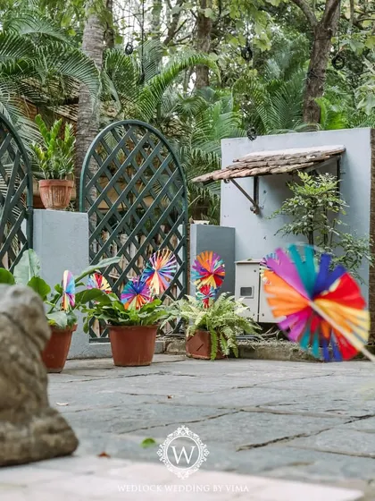 A pathway lined with colorful, handcrafted pinwheels and kites for a carnival-themed Mehendi. These playful details created a whimsical entrance for guests.