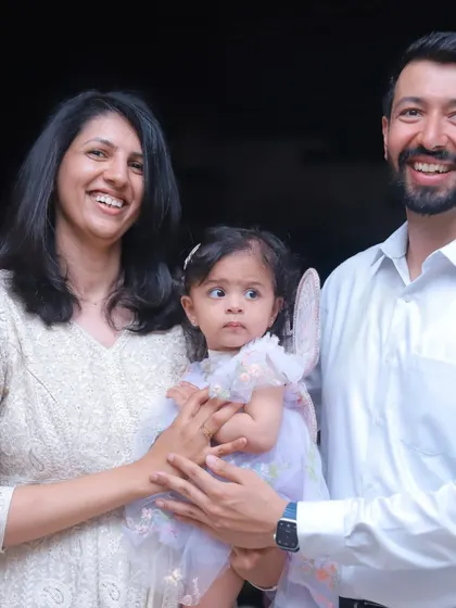 A classic family photo from a first birthday party. Even in posed shots, we aim to capture the natural connection and happiness of the family.