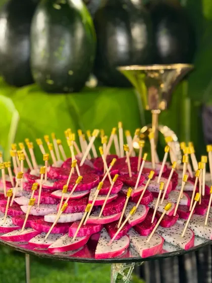 Perfectly sliced and arranged dragon fruit, ready to impress. The vibrant pink and white colors make it a stunning addition to any fruit platter.