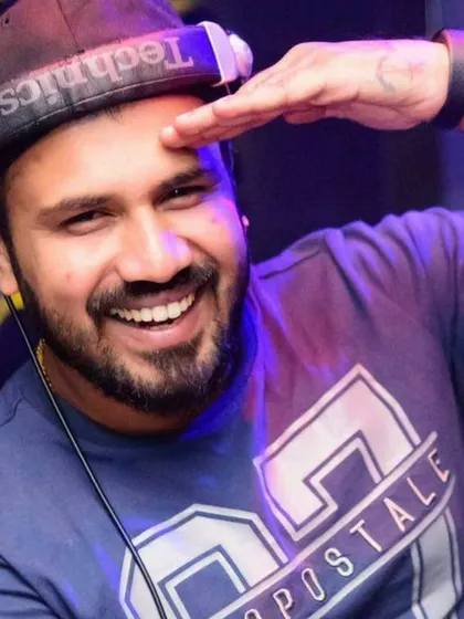 A cheerful salute from the DJ booth. I'm always ready to bring the party.