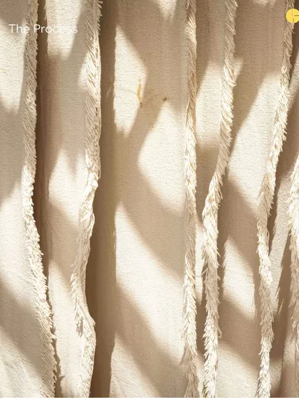 A close-up of the rug-making process, showing the texture and detail that goes into each piece.