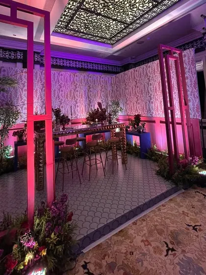 A pink gazebo-style structure frames the contemporary bar, creating an intimate and stylish corner within the larger sangeet venue.