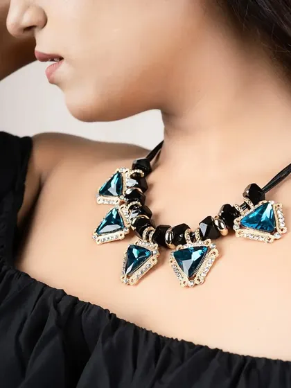 A detailed close-up of a statement necklace. This allows customers to see the quality and design of the stones and setting.