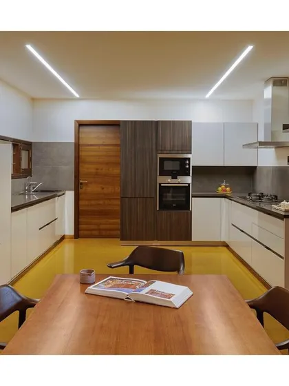 A clean, modern, and highly functional kitchen from the "Between Two Trees" project. The U-shaped layout provides ample counter space, and the material palette of white, wood, and grey is timeless.