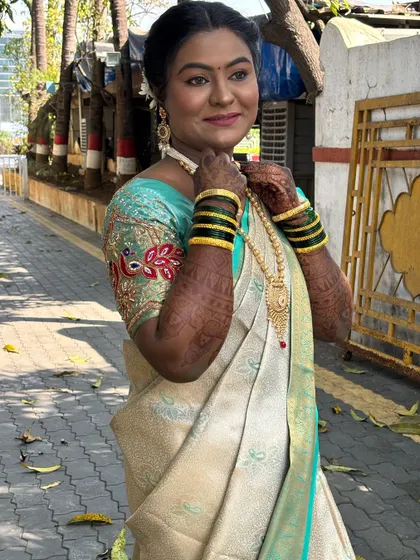 The bride adjusting her jewellery, a lovely candid moment.