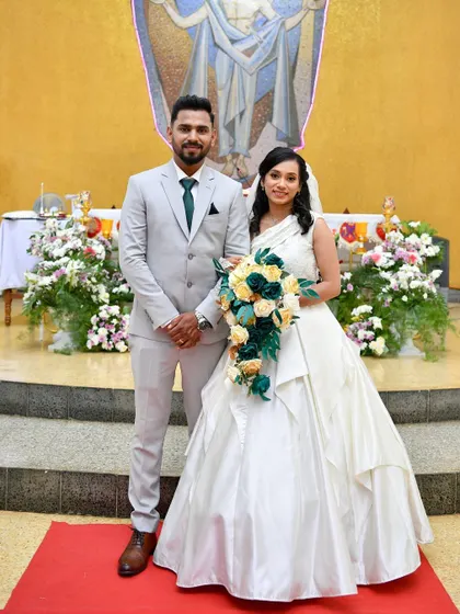 A beautiful Christian bride in her custom-designed white wedding gown. We worked together to create this elegant ball gown with a one-shoulder neckline and layered skirt.
