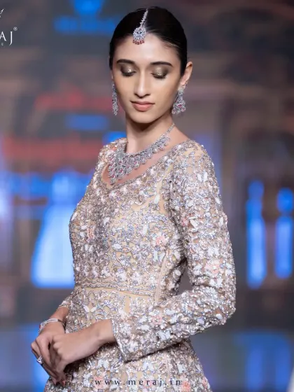Drenched in luxury, designed to dazzle. This stunning tail gown is a vision of detailed cutwork and exquisite hand embellishments.