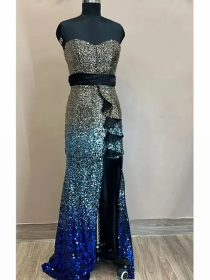 Get ready to shine at your next party with this glamorous sequin bodycon dress. This rental piece features a stunning gold to blue ombre effect and a thigh high slit, ensuring you will be the center of attention.