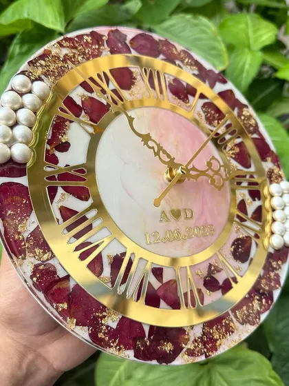 This side view shows the elegant profile of the 10-inch clock. The pearl accents on the sides are placed by hand to complement the golden Roman numeral dial.