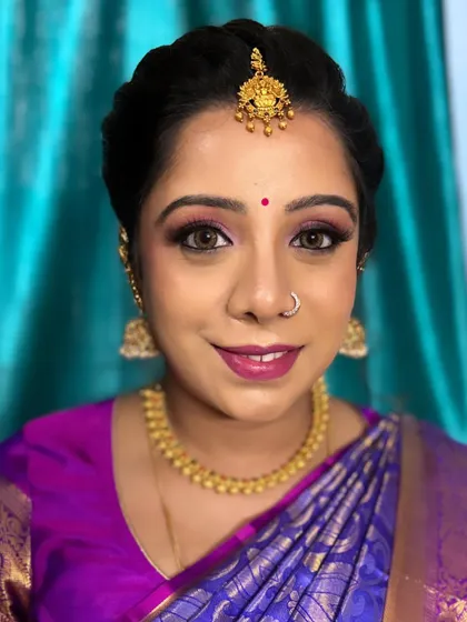 A happy client ready for her baby shower. The pink and purple eyeshadow makes her eyes pop, and her skin is glowing with happiness.