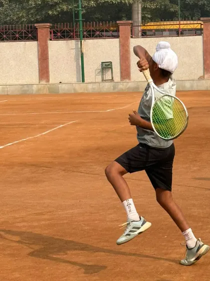 A young player lunging for a forehand, demonstrating the agility and reach we develop through our drills.