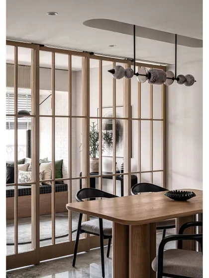 The dining area, seen through the custom wooden and glass sliding doors. This design allows for privacy when needed but maintains the open, airy feel of the space.