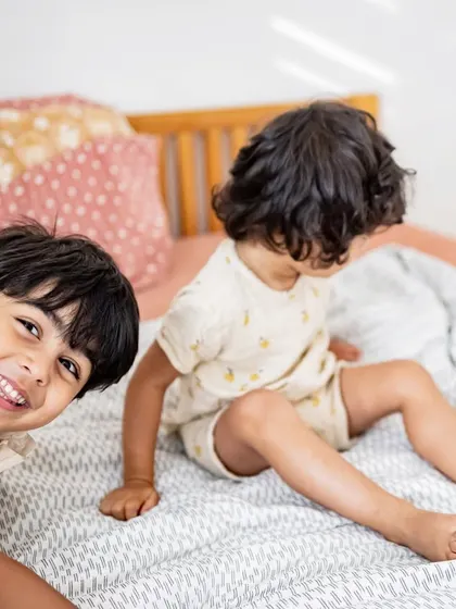 The playful bond between siblings is so special. I caught my nephew and niece in a moment of fun on the bed. These candid shots of kids just being kids are some of my absolute favorites to take.
