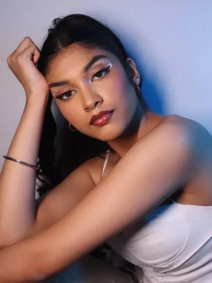 The blue backlighting adds a cinematic quality to this modern makeup look.