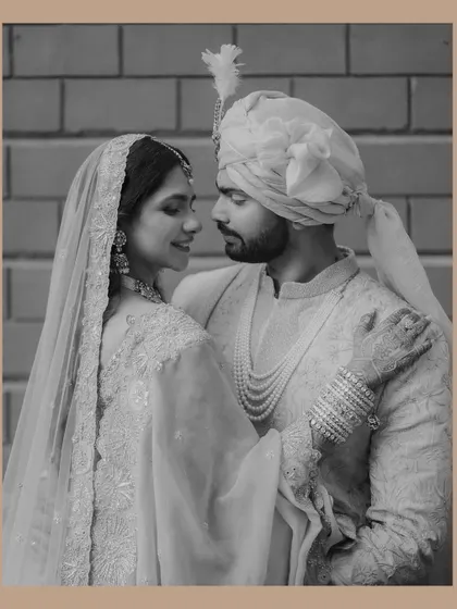 A timeless black and white portrait that feels like a classic film still. The soft light and the couple's gentle expressions create a romantic and elegant mood.