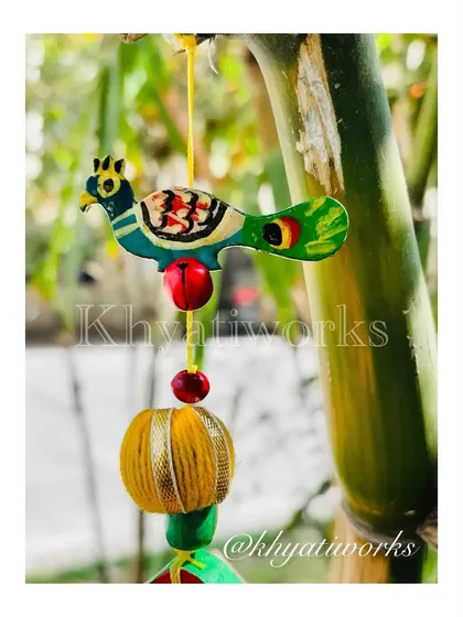 A close-up of the hand-painted bird that sits atop the kite hanging. It’s these little details that I love to add to my creations.
