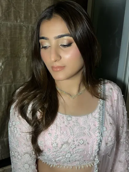 A closer look at the soft glam makeup. The glossy nude lip and perfectly blended eyeshadow create a look that is effortlessly chic and modern.