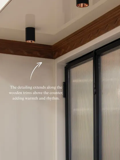 The scallop motif is a thread that runs through this kitchen, appearing here on the wooden trim above the counter. It’s a subtle, poetic detail that adds warmth, rhythm, and a unique personality to the space.
