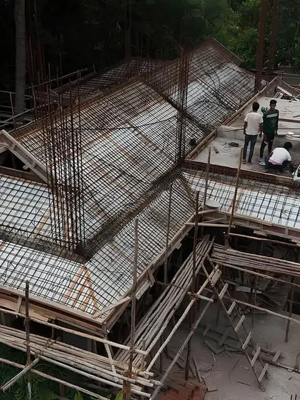 An aerial view of the roof structure for a Japanese-inspired residence under construction. The complex formwork and rebar installation show the precision required to create the building's unique silhouette.