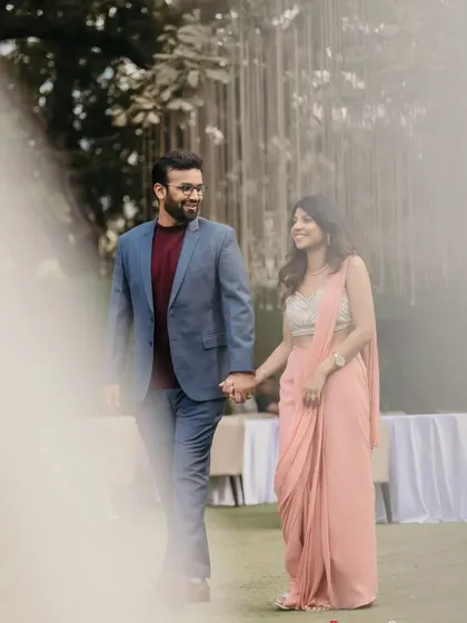 A candid moment of the couple walking hand-in-hand at their engagement. It's these simple, happy moments that build the story of your day.
