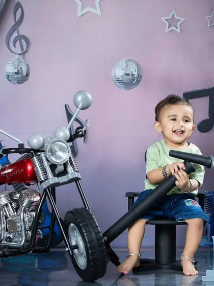 A happy moment from our rockstar session. The little one is enjoying the microphone, ready to sing his heart out.