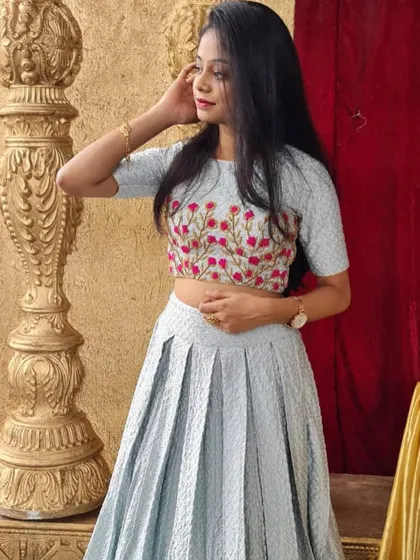 A closer look at the floral embroidered crop top paired with the light blue lehenga.