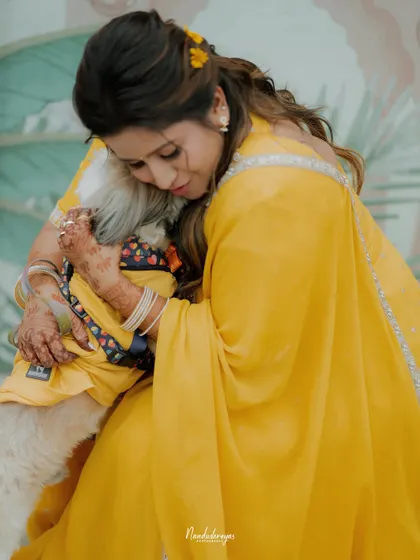 An intimate and loving hug between the bride and her pet. These are the quiet, tender moments that add so much heart to your wedding album.