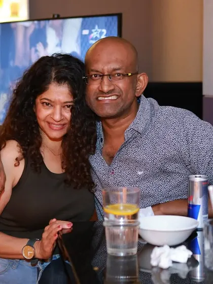 A happy couple posing for a photo at the bar. Our events are a great place to meet new people and hang out with friends.