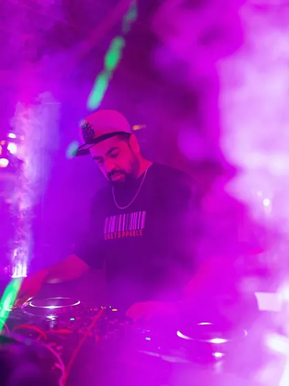 Surrounded by smoke and purple lights, I'm in my element, dropping global sounds for the Friday night crowd at Pebble.