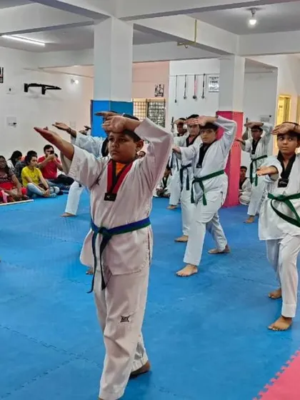 Green and blue belt students practicing a knife-hand strike.