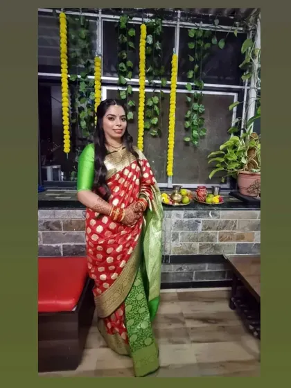 This beautiful red and green Banarasi saree is a classic combination. The drape is kept simple to let the rich colors and fabric be the focus.