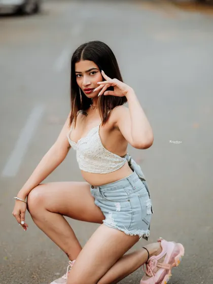 A dynamic kneeling pose in the middle of the street, creating a bold and unconventional fashion portrait. I encourage models to experiment with poses to get unique shots.