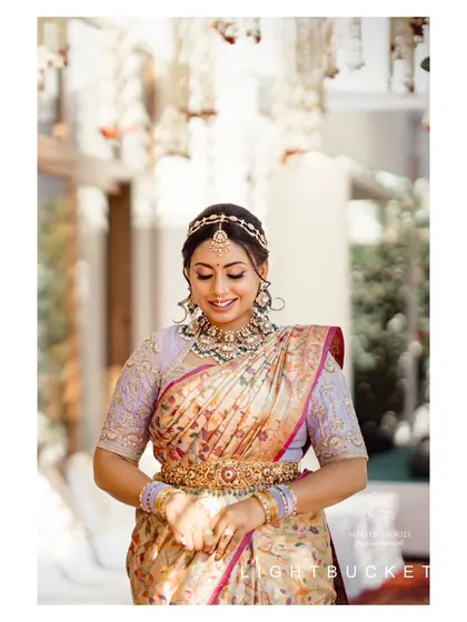 A beautiful smiling shot of Nidhi at her bangle ceremony. The makeup is bright and radiant, capturing the joy and excitement of the pre wedding festivities.