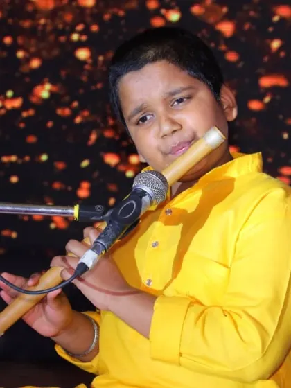 A close-up of our young flutist, completely absorbed in his performance on stage. We train our students to perform with confidence and soul, connecting deeply with their instrument and the music.