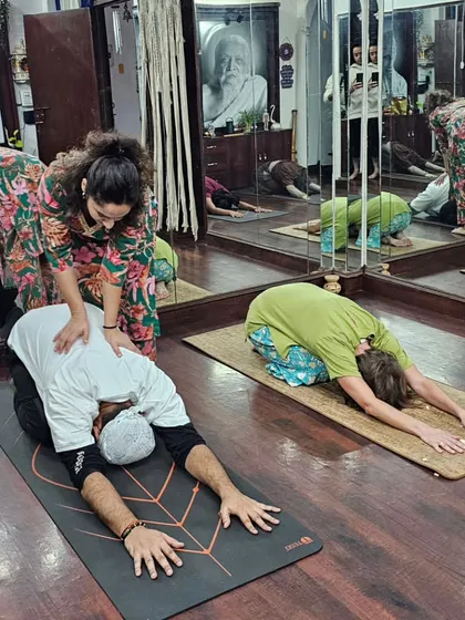 Here in my Delhi studio, I'm providing a hands-on adjustment during a Teacher Training class. I believe in giving personalized attention to help each student safely deepen their posture and understand the alignment of each asana.