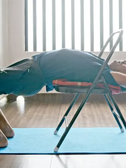 Dwi Pada Viparita Dandasana on the chair is an intense backbend that builds strength and flexibility. It's a journey inward, balancing challenge with grace.