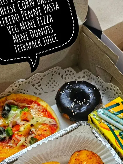 A look inside one of my customized snack boxes for a birthday girl. This one includes a mini pizza, cheese corn balls, a mini donut, and a juice box.
