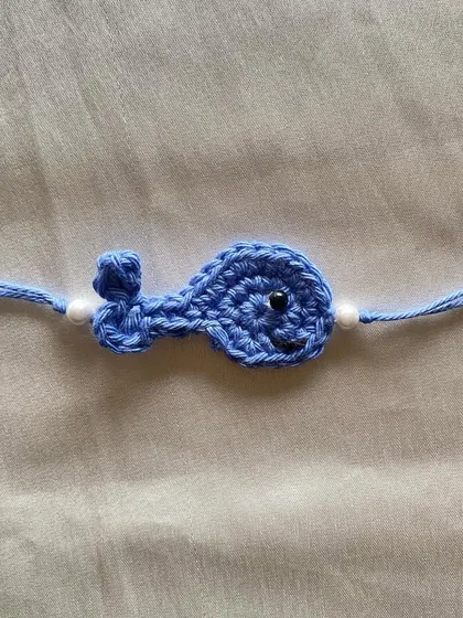 Our cute and simple crochet whale rakhi. This is another example of the creative and child-friendly designs we offer for special occasions.