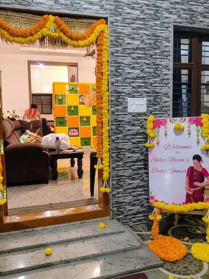 The entrance to the home baby shower, decorated with marigold garlands.