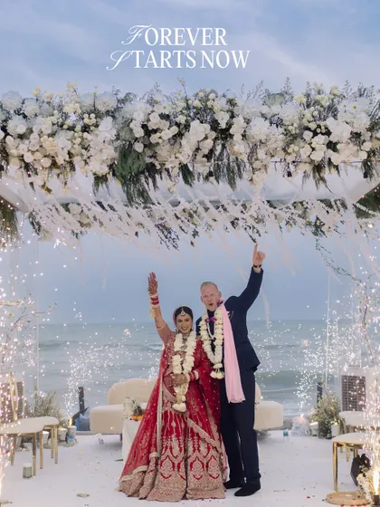 As sparklers lit up the twilight sky over the ocean, they threw their hands up in pure joy. This is the moment forever begins, a perfect, explosive celebration of two people, two families, and one incredible future.