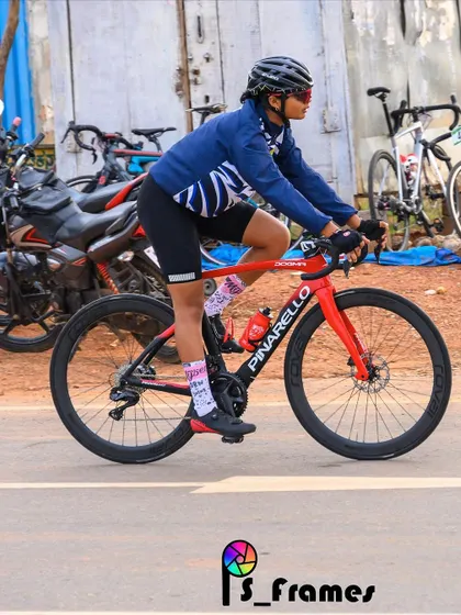 A female rider on her Pinarello race bike, captured during a race. We celebrate our women racers who are breaking barriers and setting new benchmarks.