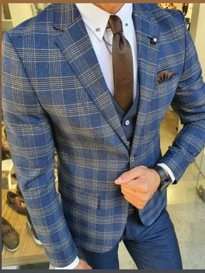 A stylish blue and beige plaid three-piece suit. I can work with various patterns and fabrics to create a suit that matches your personal style.