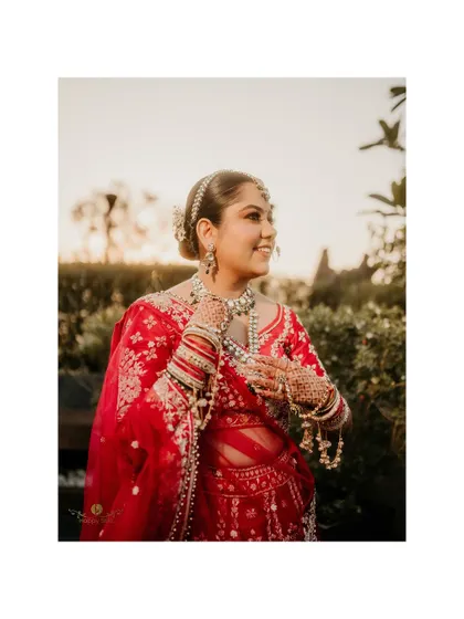 A lovely outdoor portrait of the bride, her smile as bright as the day. This shot captures her joy and the beauty of her wedding look.