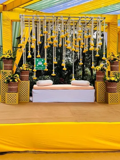 The complete Haldi stage, a perfect blend of modern structure and traditional floral decoration.