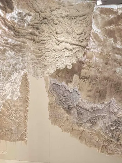 A close-up of the hand-stitched and felted fabrics from the 'Sleep Sense' installation. The textures are designed to be breathable and calming, reflecting a renewed focus on natural materials that aid in rest and wellness.