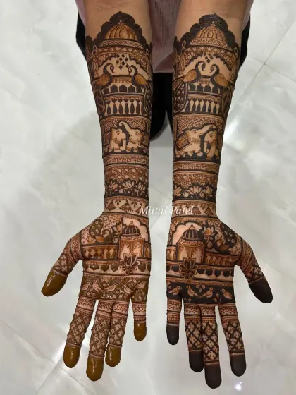 An elegant engagement design featuring traditional Indian architecture (jharokhas), lotus flowers, and elephants, covering the hands and forearms.