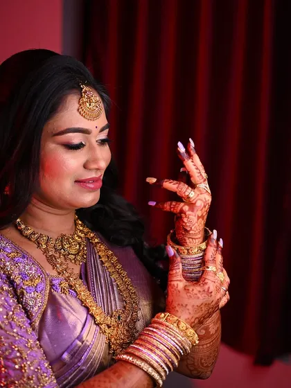 The elegance of bride Lavanya, her hands adorned with a beautiful mehendi stain and colorful bangles.