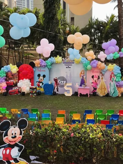 The happiest party on Earth! A massive Disneyland-themed setup with characters from Mickey Mouse, Princesses, and Cars, all ready for a 'Twin-finity & Beyond' celebration.