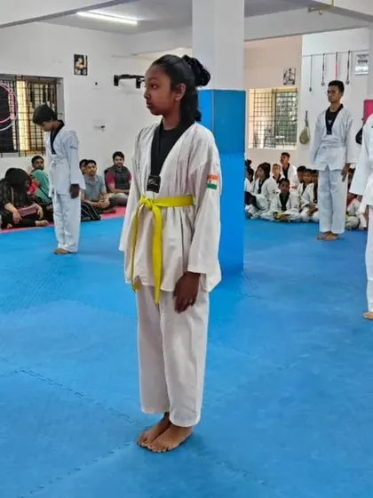 A line of yellow belts standing at attention.