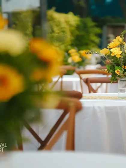 A close-up of the simple yet elegant sunflower centerpieces on the guest tables.